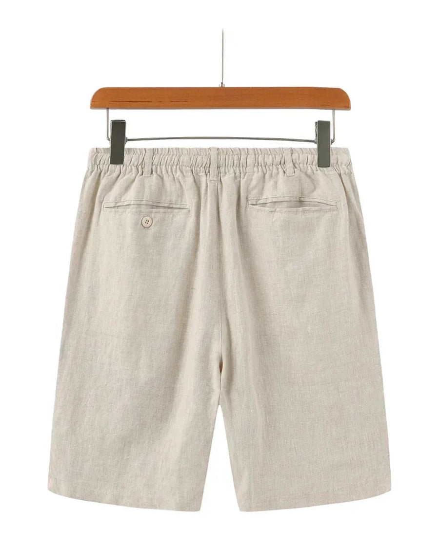 Beige linen shorts on a hanger, back view
