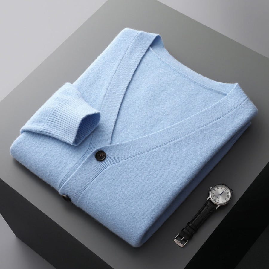 Light blue V-neck cardigan folded, buttons and cuff close-up