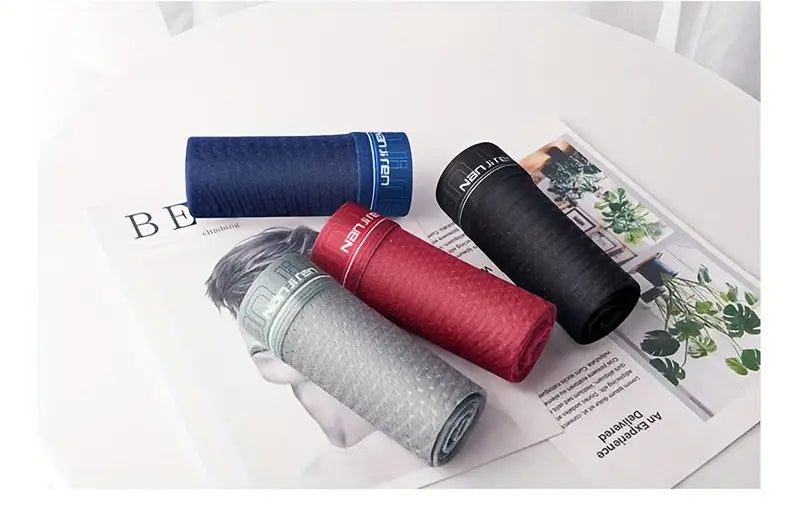 Men's Perforated Silk-Feel Boxer Briefs – boxers rolled up on the table in four colours